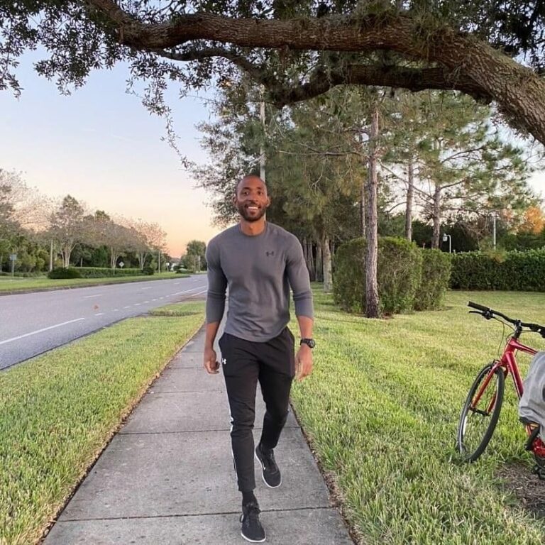 Picture of Moses walking down sidewalk. He appears skinny.