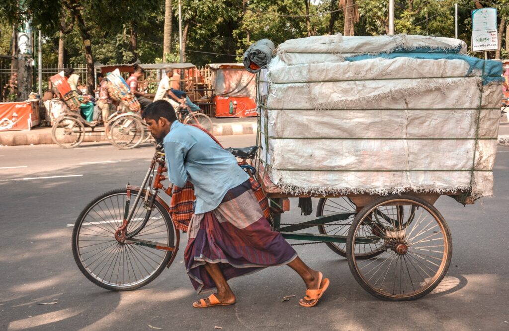 Man pushing a heavy cart