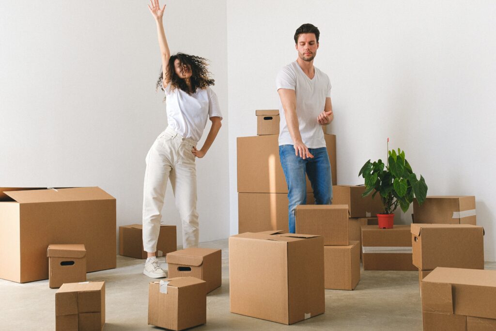 A couple with stuff in scattered boxes