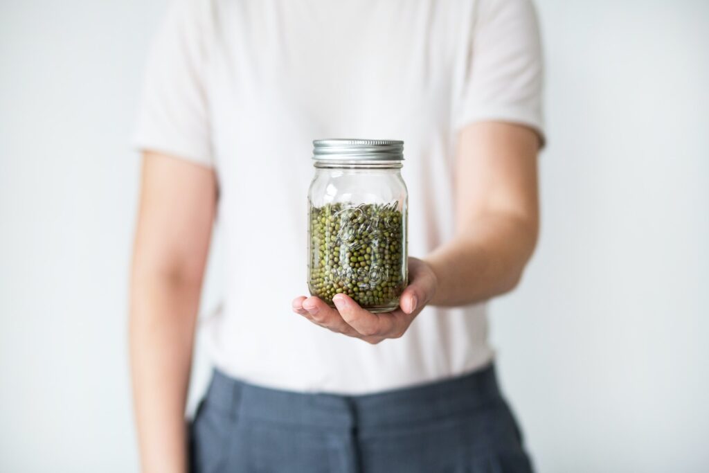 Man holding a jar of insecurity.